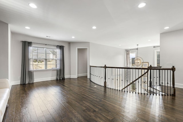 unfurnished room featuring dark hardwood / wood-style flooring