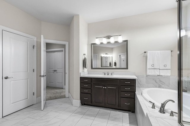 bathroom with vanity and tiled bath