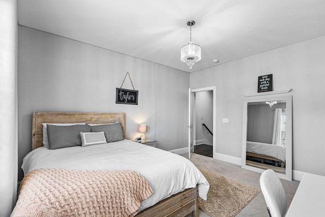 bedroom with carpet and a notable chandelier