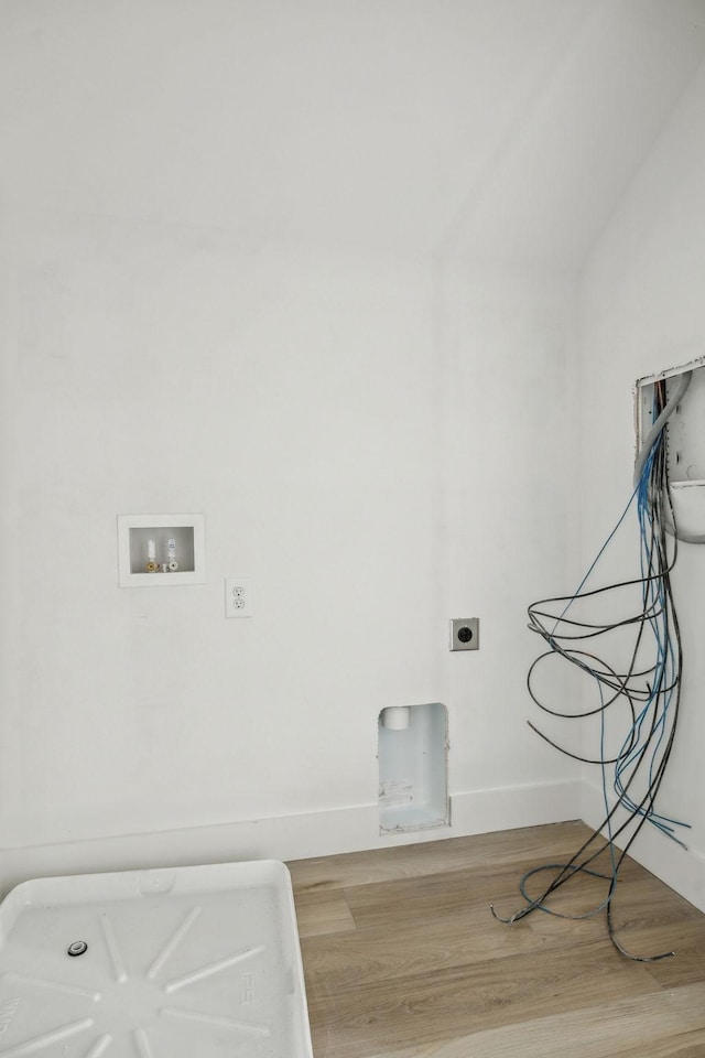 laundry area with light hardwood / wood-style floors, hookup for a washing machine, and electric dryer hookup