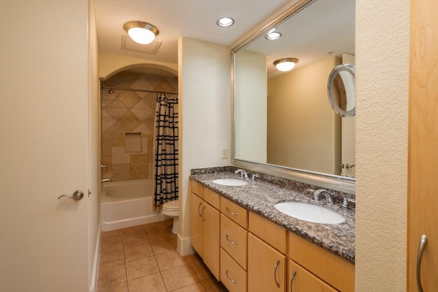 full bathroom with shower / bathtub combination with curtain, vanity, tile patterned floors, and toilet