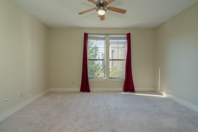 spare room featuring ceiling fan and light colored carpet