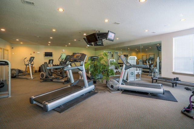 gym featuring a textured ceiling