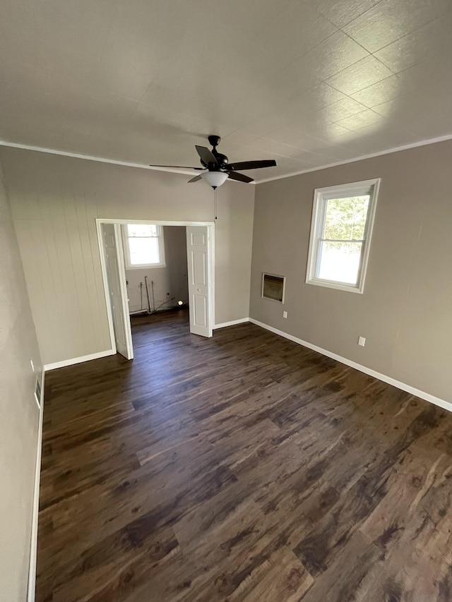 unfurnished room with ceiling fan, ornamental molding, and dark hardwood / wood-style floors