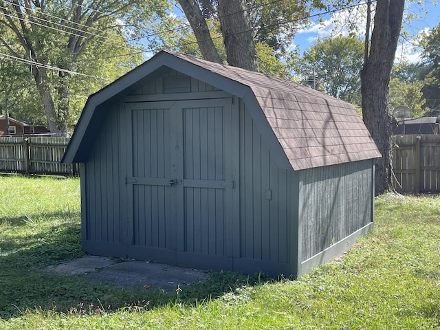 view of outbuilding featuring a lawn