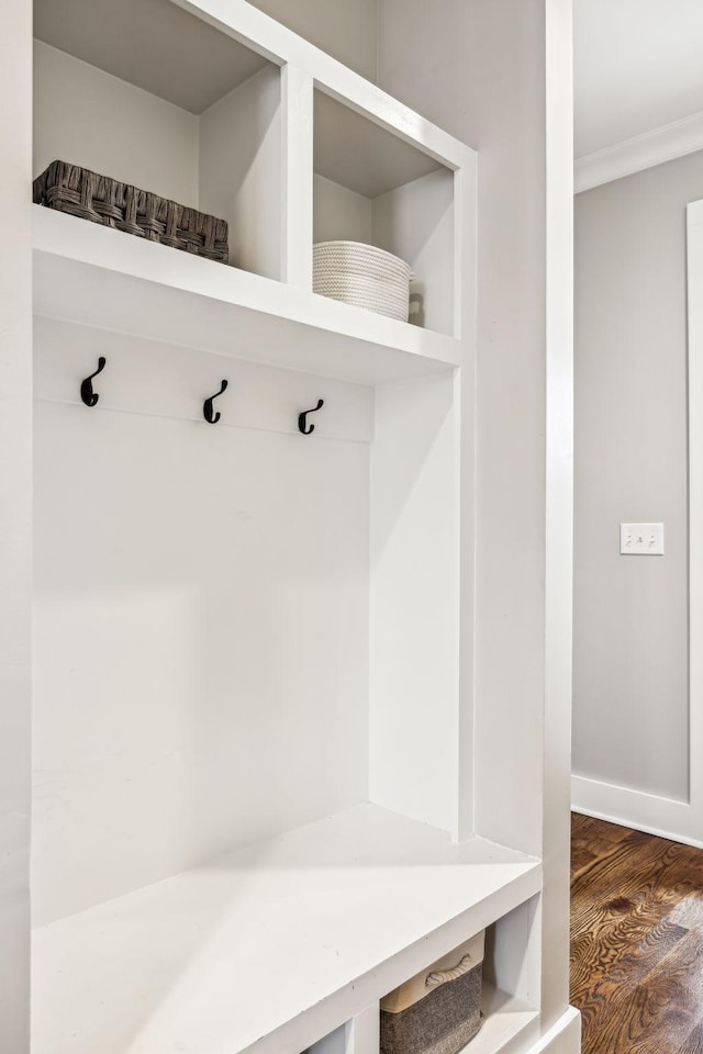 mudroom with crown molding and dark hardwood / wood-style flooring