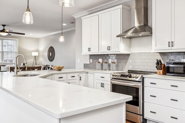 kitchen featuring decorative light fixtures, white cabinetry, sink, stainless steel range with electric cooktop, and wall chimney exhaust hood