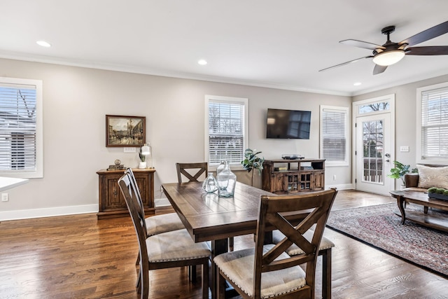 dining room with crown molding, dark hardwood / wood-style floors, and a wealth of natural light