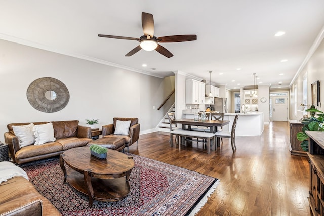 living room with crown molding, ceiling fan, dark hardwood / wood-style flooring, and sink