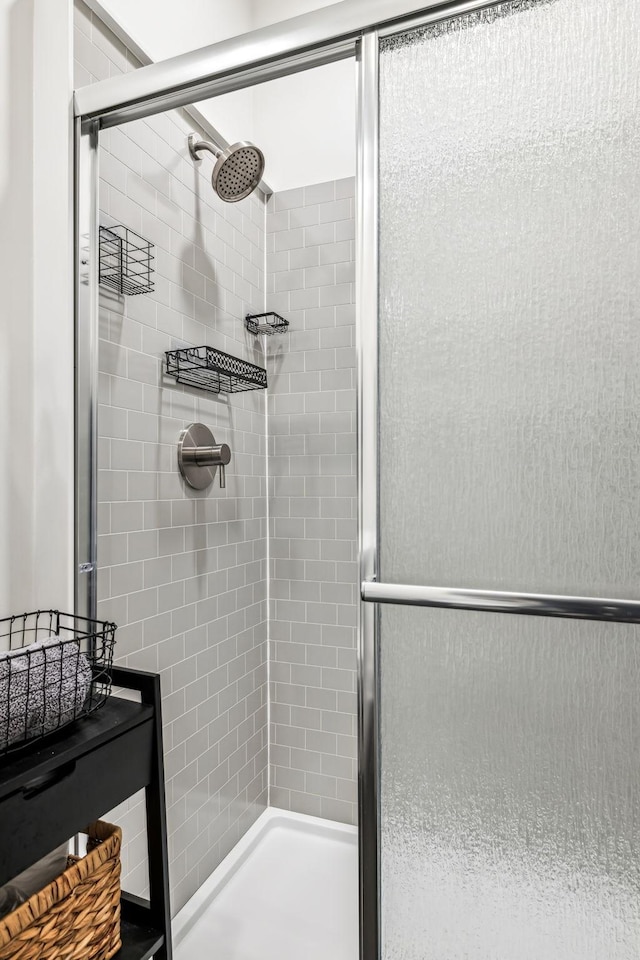 bathroom featuring a shower with door