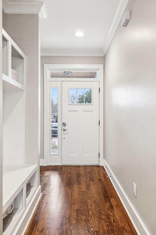 mudroom with ornamental molding and dark hardwood / wood-style floors