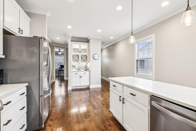 kitchen with pendant lighting, stainless steel appliances, and white cabinets