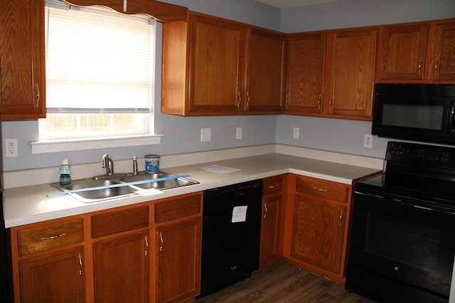 kitchen featuring sink, dark hardwood / wood-style flooring, and black appliances