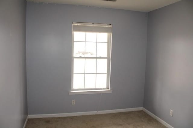 unfurnished room with light colored carpet