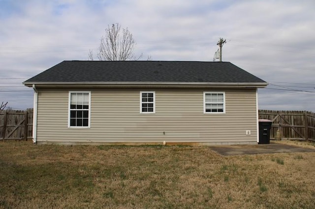 view of side of property with a patio area and a lawn