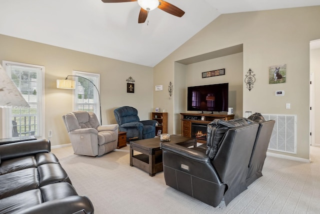 carpeted living room featuring vaulted ceiling and ceiling fan