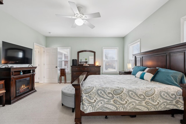 bedroom with light carpet and ceiling fan