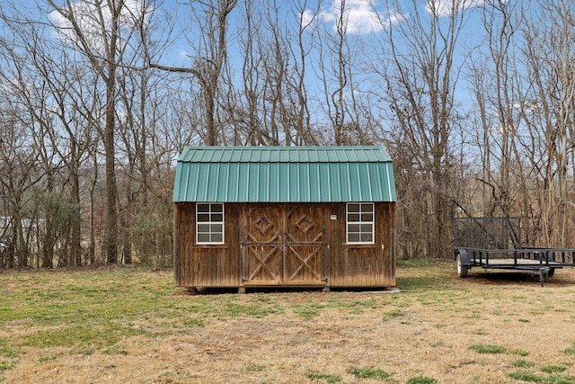 view of outdoor structure with a lawn