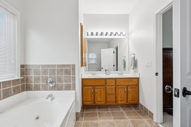 bathroom with vanity, tile patterned flooring, and a bathtub