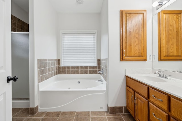 bathroom with tile patterned floors, plus walk in shower, and vanity