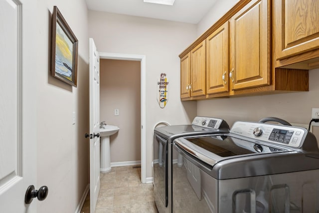 laundry area with cabinets, light tile patterned flooring, and separate washer and dryer