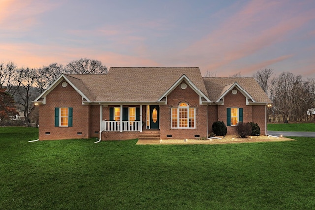 single story home with covered porch and a lawn