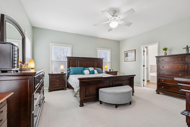 carpeted bedroom featuring connected bathroom and ceiling fan