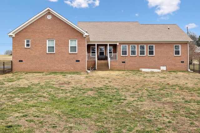 rear view of property featuring a yard