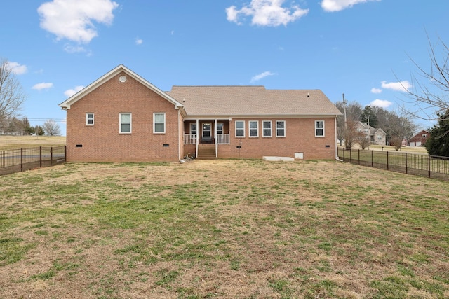 rear view of property with a lawn