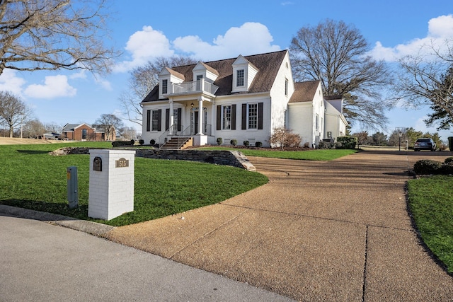 cape cod-style house with a front lawn