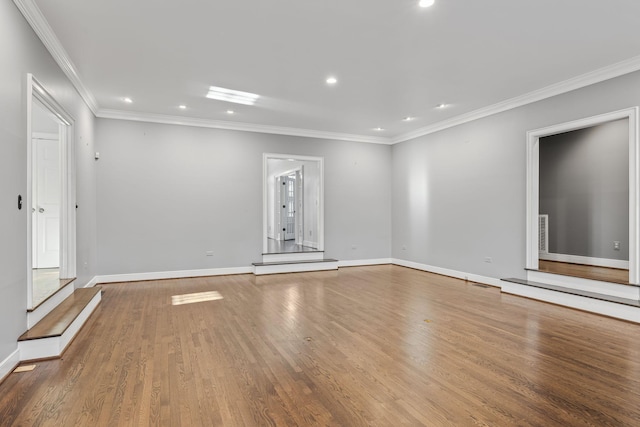 unfurnished living room featuring hardwood / wood-style floors and ornamental molding