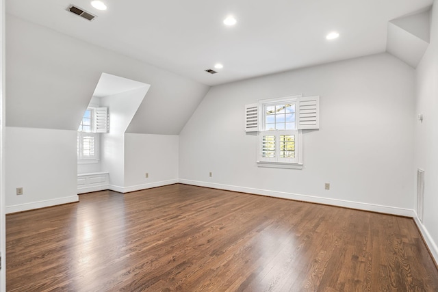 bonus room featuring lofted ceiling and dark hardwood / wood-style flooring