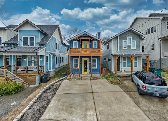 view of front of property featuring a balcony and a porch