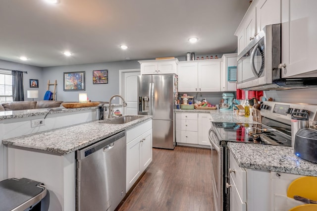 kitchen featuring light stone counters, stainless steel appliances, sink, and white cabinets