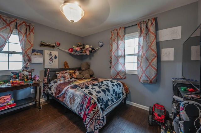 bedroom with dark hardwood / wood-style flooring