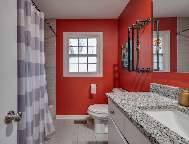 full bathroom featuring vanity, shower / tub combo, and toilet