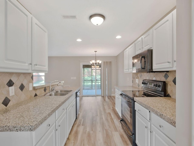 kitchen with white cabinetry, sink, and black appliances