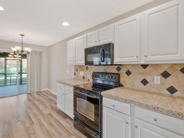 kitchen featuring hanging light fixtures, decorative backsplash, white cabinets, and black appliances