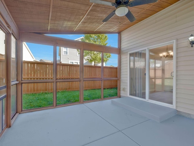 unfurnished sunroom with wood ceiling, vaulted ceiling, and ceiling fan