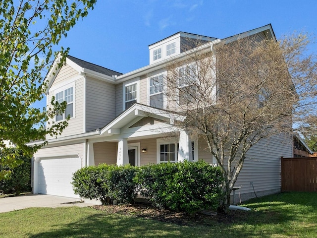 view of front of house with a garage, a front yard, and covered porch