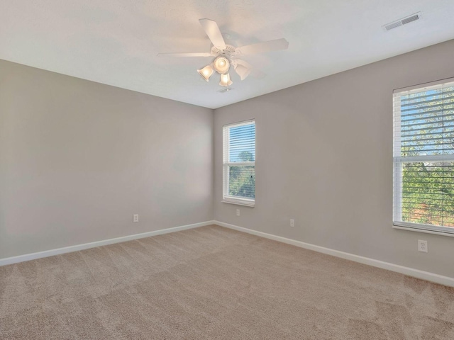 carpeted empty room featuring ceiling fan