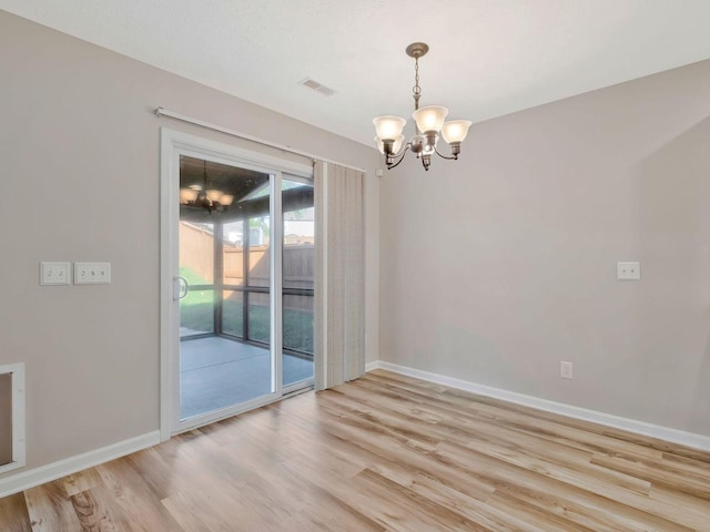 interior space featuring a chandelier and light hardwood / wood-style flooring