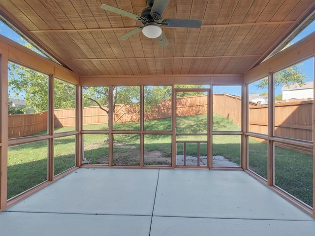 unfurnished sunroom featuring vaulted ceiling, wooden ceiling, and ceiling fan