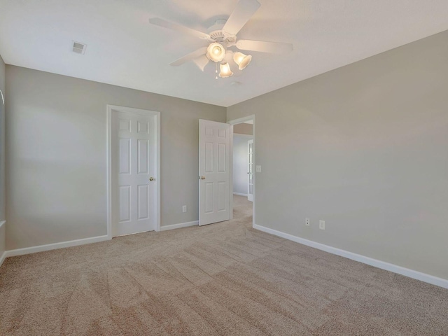 unfurnished bedroom featuring light colored carpet and ceiling fan