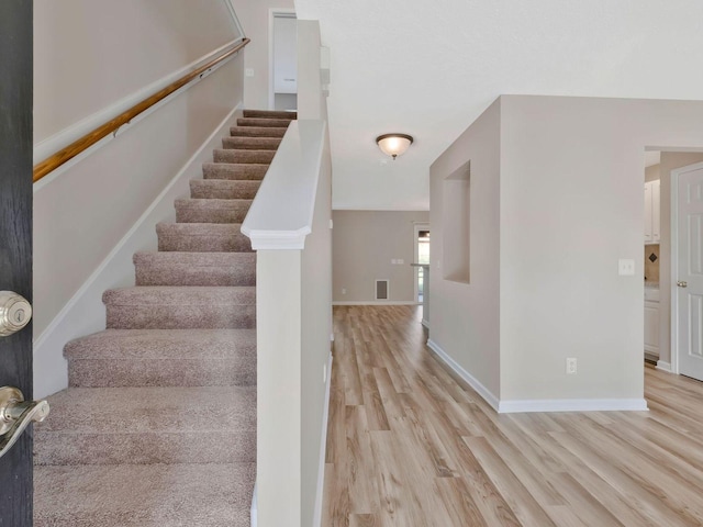 stairs with wood-type flooring