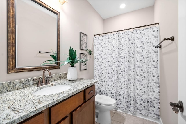 bathroom with vanity, toilet, and tile patterned flooring