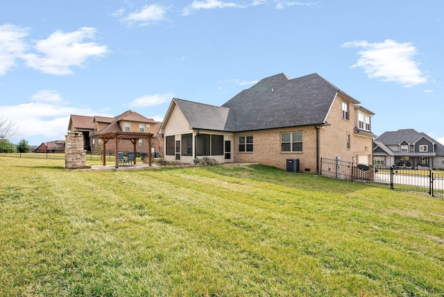 rear view of house with a pergola, a patio area, and a lawn