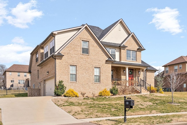 view of front of house featuring a porch, a garage, and a front yard