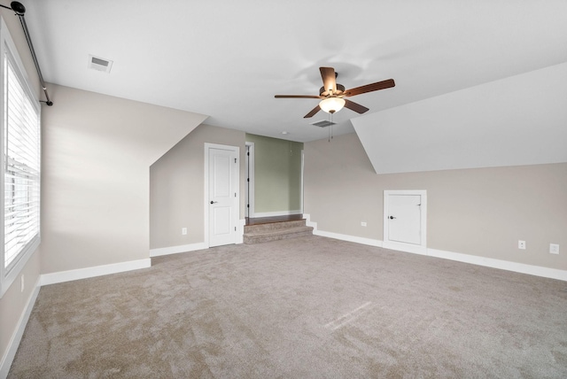 bonus room featuring lofted ceiling, carpet floors, and ceiling fan