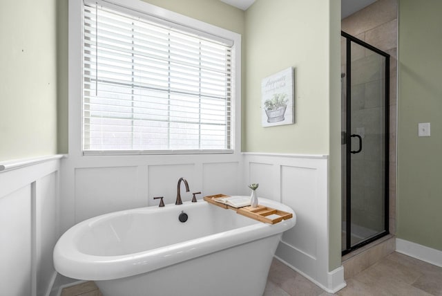 bathroom with independent shower and bath and tile patterned flooring